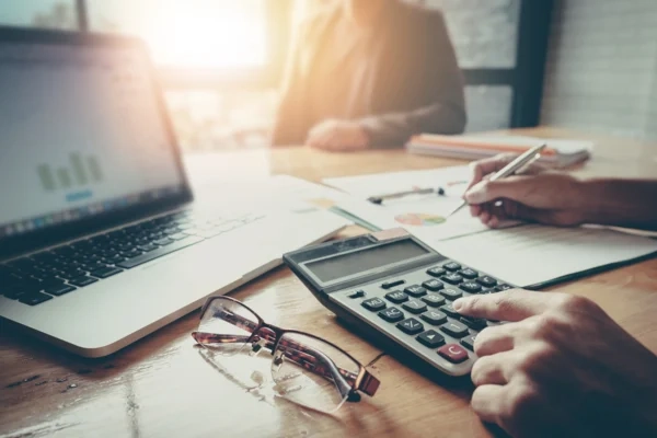 A business person using a calculator